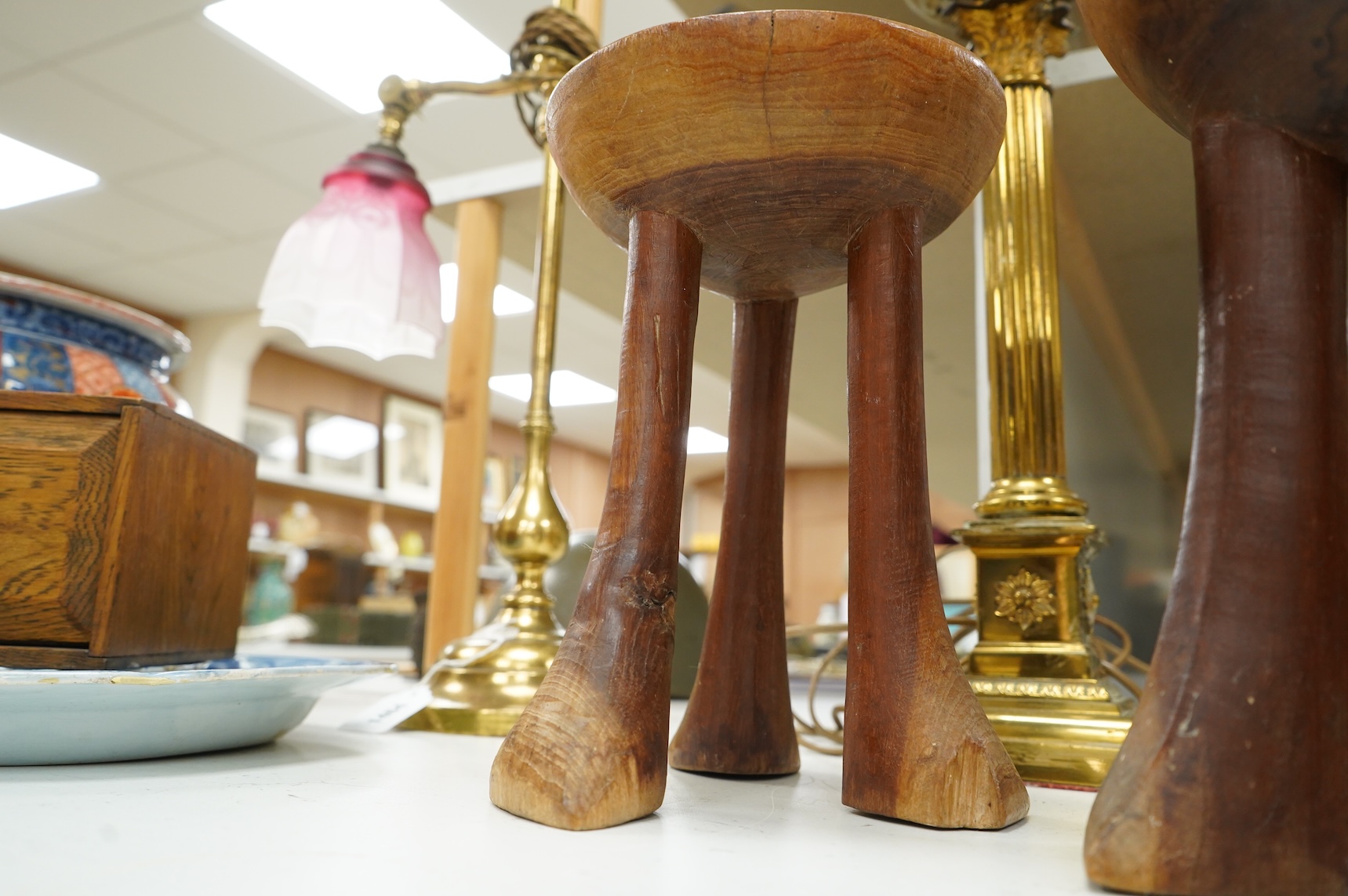 Two African tribal carved hardwood three-legged stools, tallest 28.5cm